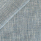A high-performance upholstery fabric from Tonic Living, with a sky blue and natural beige linen-look texture.