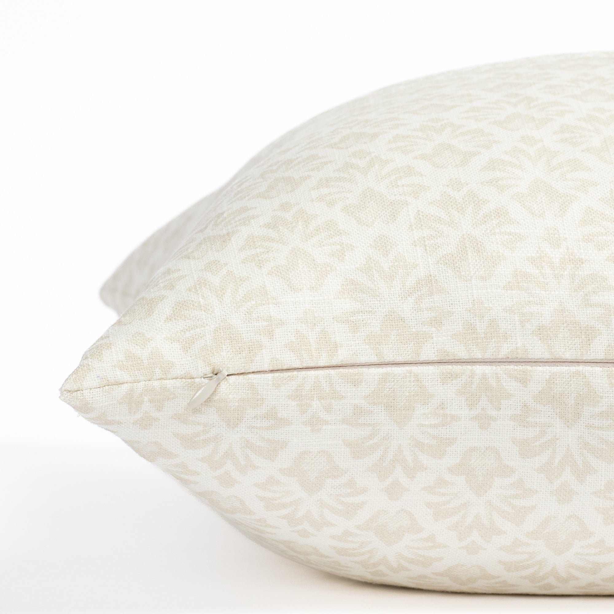 a cream and putty beige floral block print throw pillow : close up zipper view