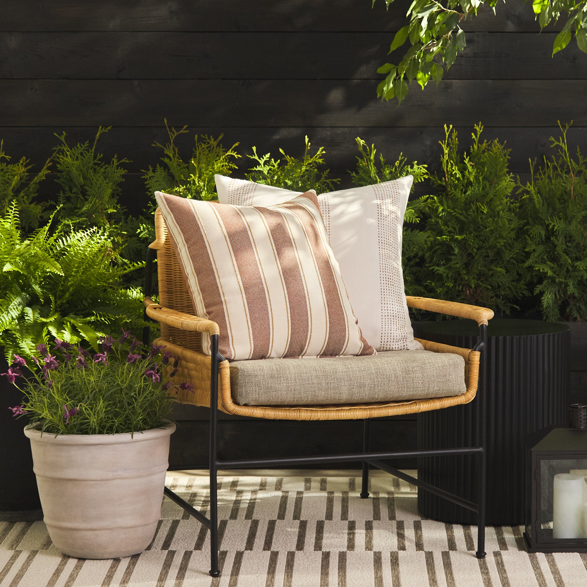 Tonic Living Sentiment Terracotta outdoor cushion styled on a chair with Caper Linen 22x22 pillow in a neutral outdoor setting.