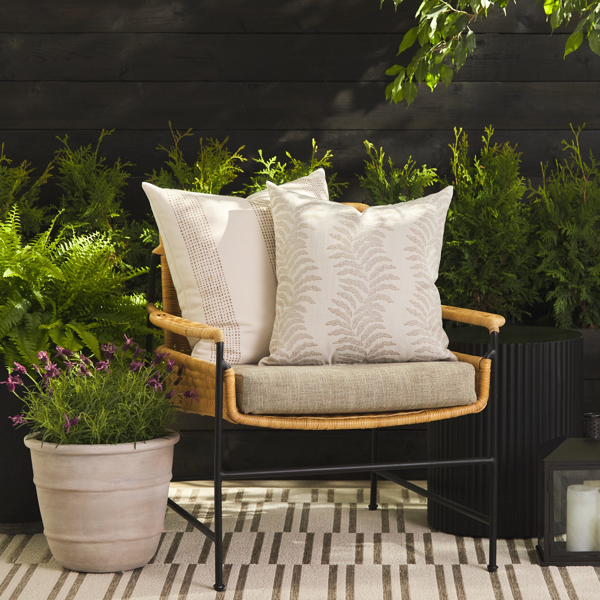Tonic Living Swoon Sand outdoor cushion styled on a chair with the Caper Linen 22x22 pillow in a neutral outdoor setting.