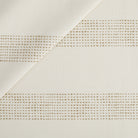 Tonic Living Caper Sunbrella Outdoor Fabric in Linen, a creamy white indoor/outdoor upholstery fabric with dotted stripe.