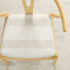 Tonic Living Caper Sunbrella Linen indoor/outdoor upholstery fabric on a dining chair seat in off-white and tan stripe.