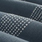 Close up of Tonic Living Caper Sunbrella Slate fabric showing raised stitched stripe detail in slate blue and white.