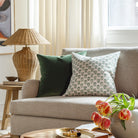 Beautiful green designer throw pillows from Tonic Living, styled in a living room.