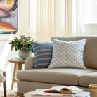 Blue patterned throw pillows from Tonic Living, styled in a living room.