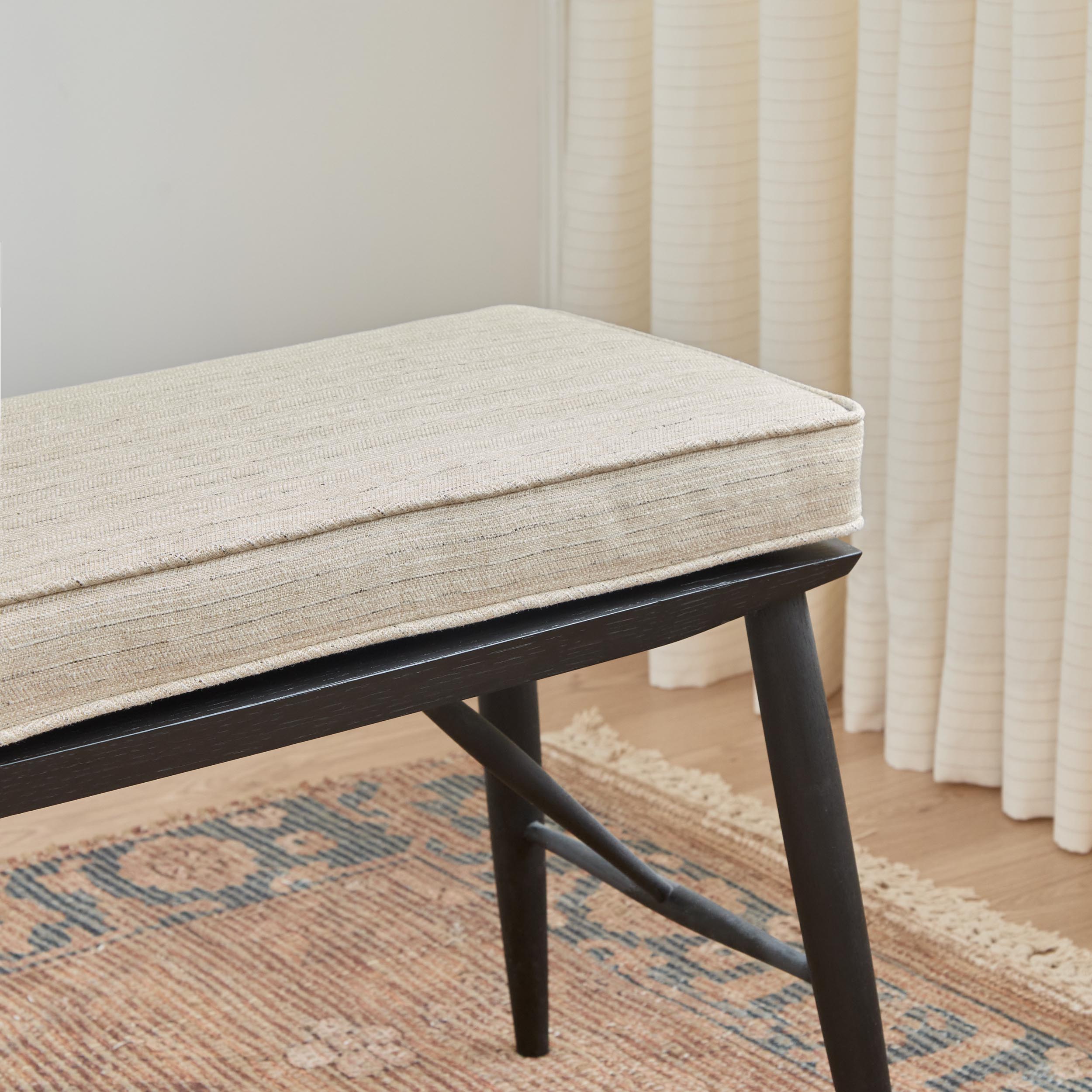 Chester Fabric, Flax by Tonic Living — high-performance upholstery fabric in soft neutral herringbone, shown on a bench seat cushion.