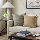 Tonic Living Sterling Velvet Bark decorative cushion styled on a sofa with a coordinating blue striped throw pillow.