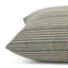 Side view of Tonic Living Clark Stripe Pool toss cushion highlighting its muted blue and neutral multistripe pattern.