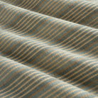 Tonic Living Clark Stripe Pool performance upholstery fabric featuring a multi-stripe pattern in faded blue and warm neutrals.