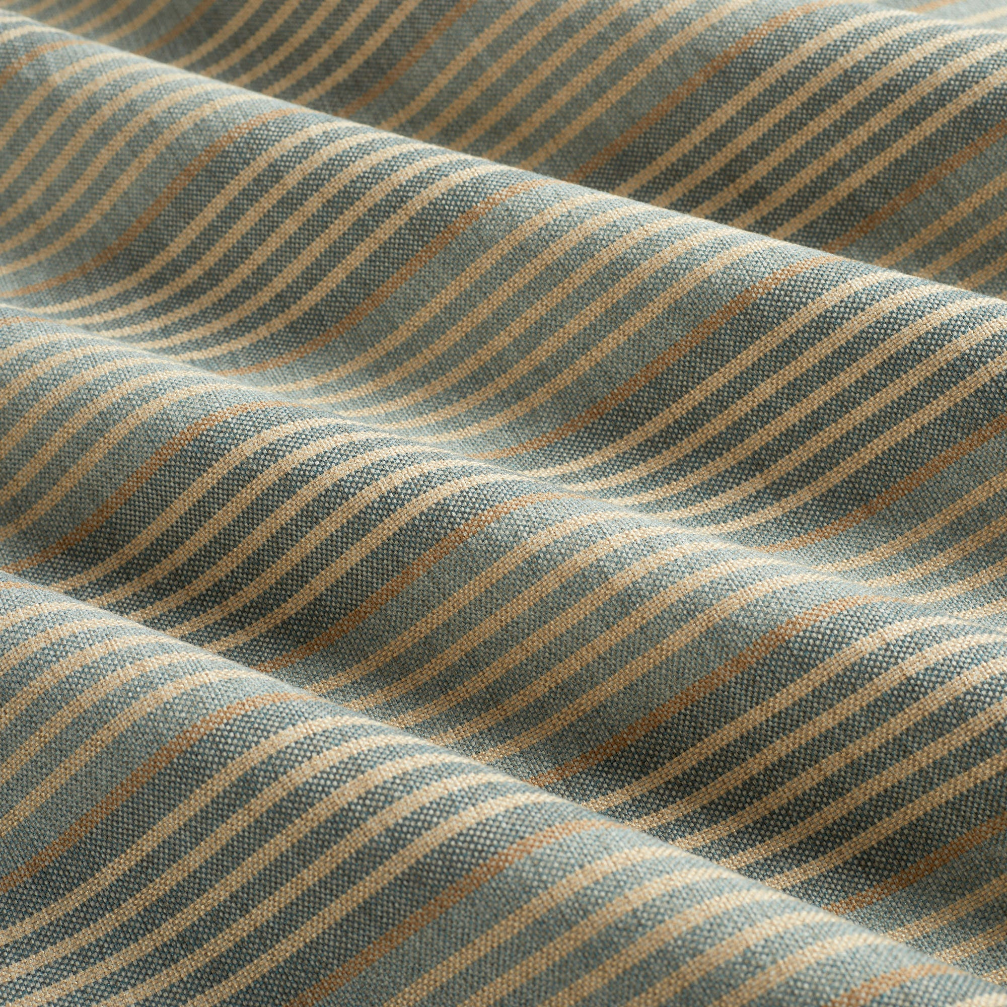 Tonic Living Clark Stripe Pool performance upholstery fabric featuring a multi-stripe pattern in faded blue and warm neutrals.