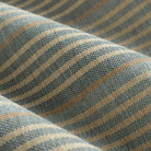 Close up of Tonic Living Clark Stripe Pool fabric showing faded blue, oatmeal, and camel stripes with woven texture.