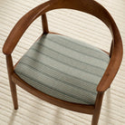 Tonic Living Clark Stripe Pool high-performance fabric shown upholstered on a dining chair seat with muted blue stripes.