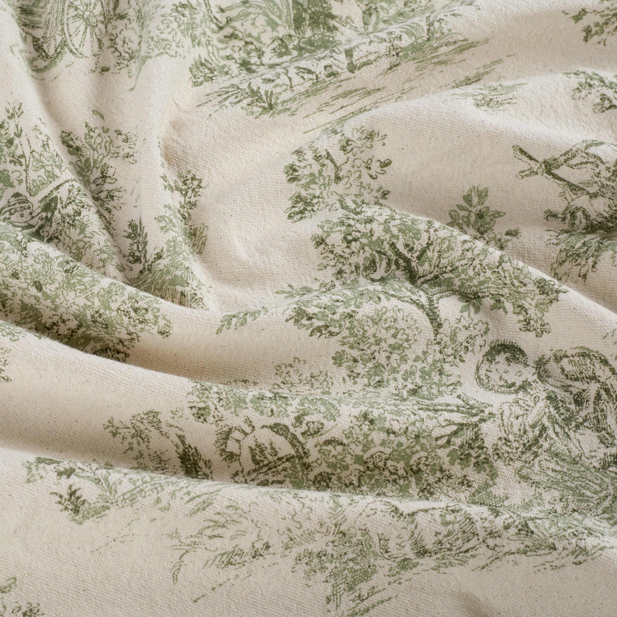 Tonic Living Colette Forest Green multi-use home decor fabric featuring scenic toile vignettes in green and beige.