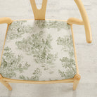 Tonic Living Colette Forest Green upholstery fabric shown on a chair seat with a French toile pattern.