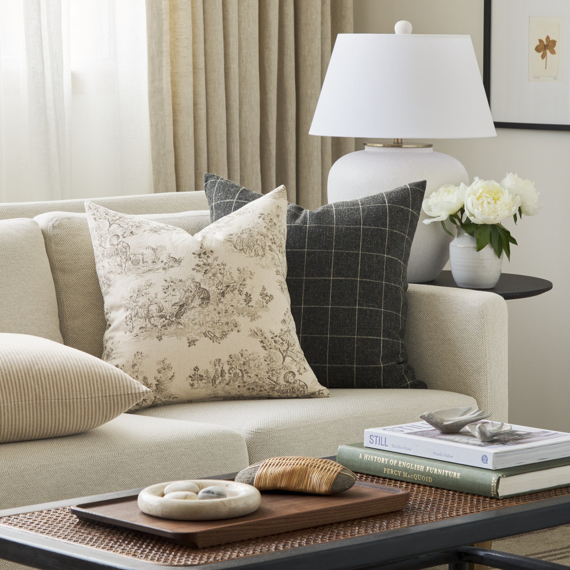 Tonic Living Colette Portobello decorative pillow styled on a sofa with the Dundee 22x22 Pillow in Sable.