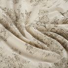 Tonic Living Colette Portobello multi-use home decor fabric featuring scenic toile vignettes in beige and brown.
