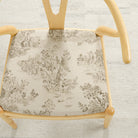 Tonic Living Colette Portobello upholstery fabric shown on a chair seat with a French toile pattern.