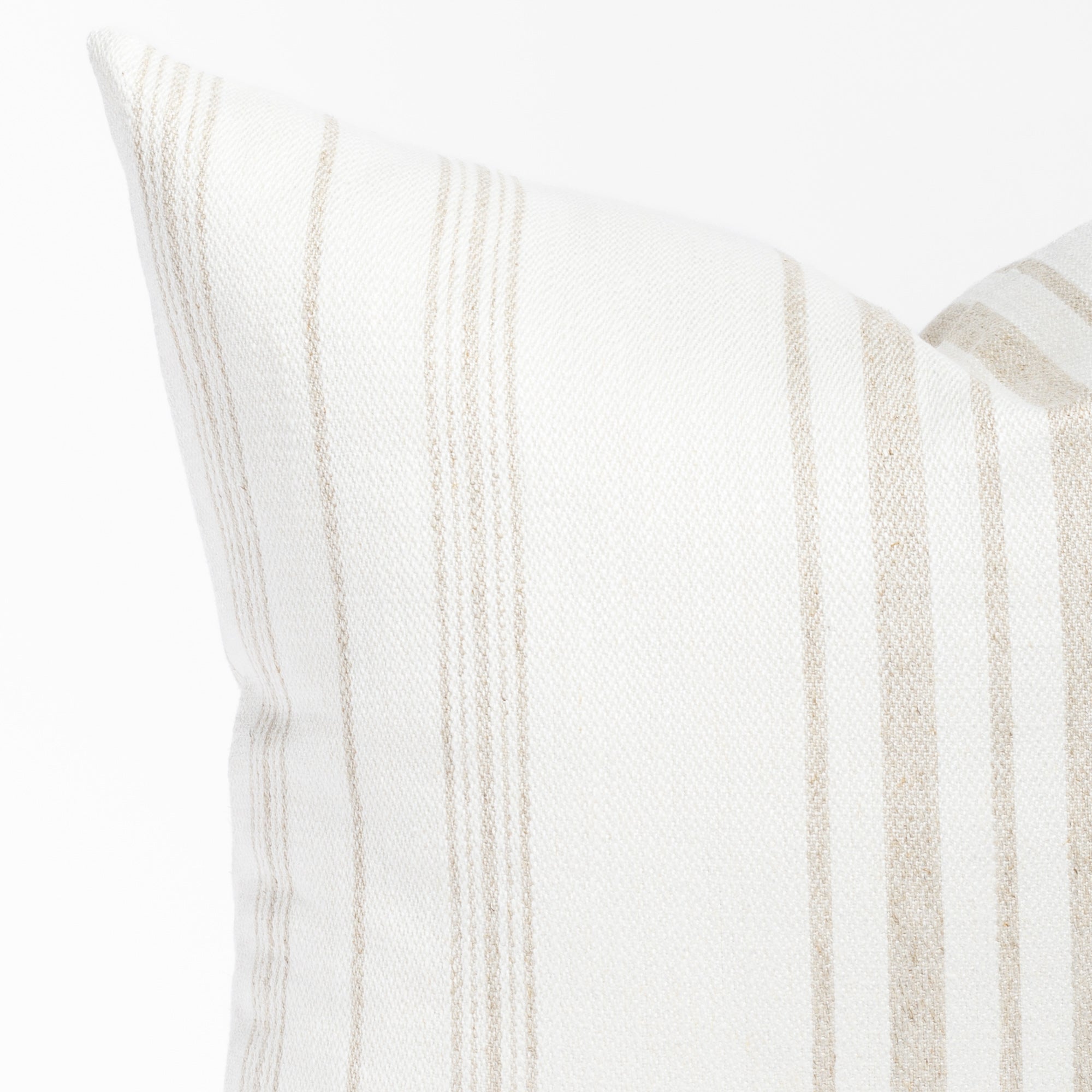 a flax beige and white vertical stripe throw pillow : corner detail