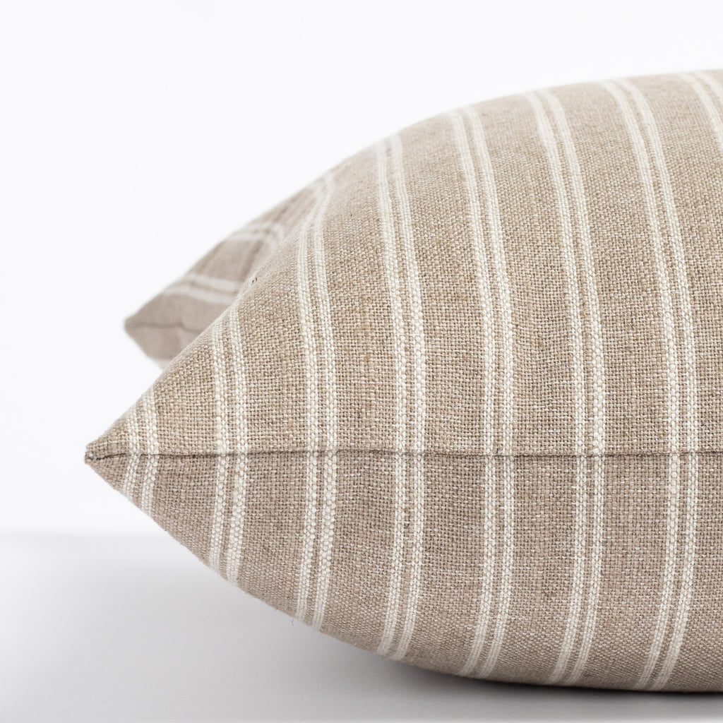 a light brown and oatmeal beige vertical stripe throw pillow : close up side view