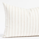 a soft white and beige stripe lumbar pillow 