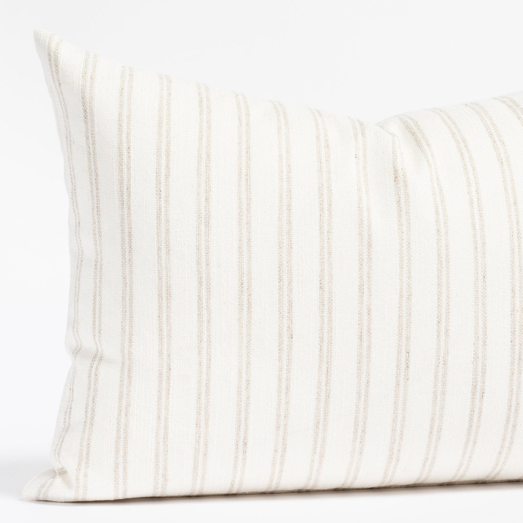 a soft white and beige stripe lumbar pillow 