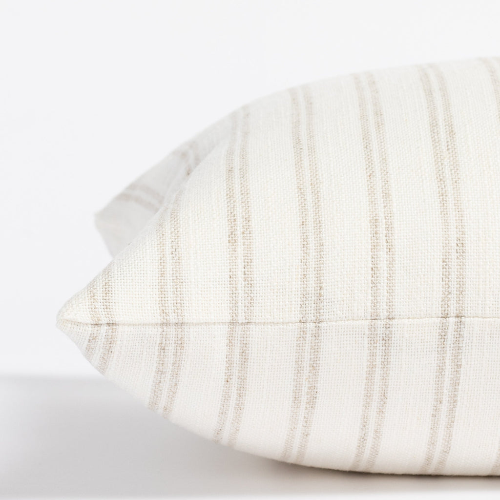 a soft white and beige stripe lumbar pillow : close up side view