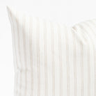 a soft white and beige vertical stripe style throw pillow : close up view