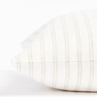 a soft white and beige vertical stripe style throw pillow : close up side view