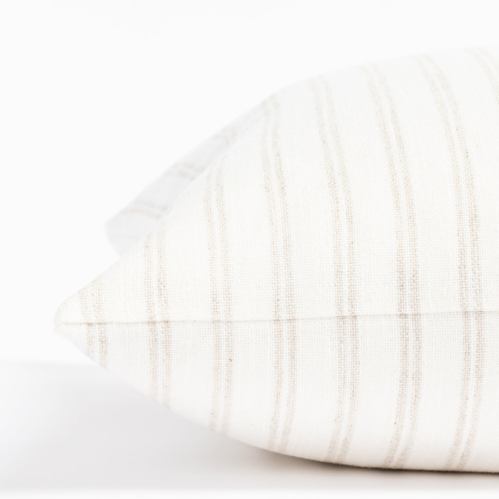 a soft white and beige vertical stripe style throw pillow : close up side view