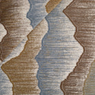 Tonic Living Cortina Fabric in Storm, a blue and brown abstract upholstery fabric with an organic woven pattern.