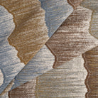 Tonic Living Cortina Storm woven jacquard fabric featuring layered abstract shapes in rich blue, brown, and neutral tones.