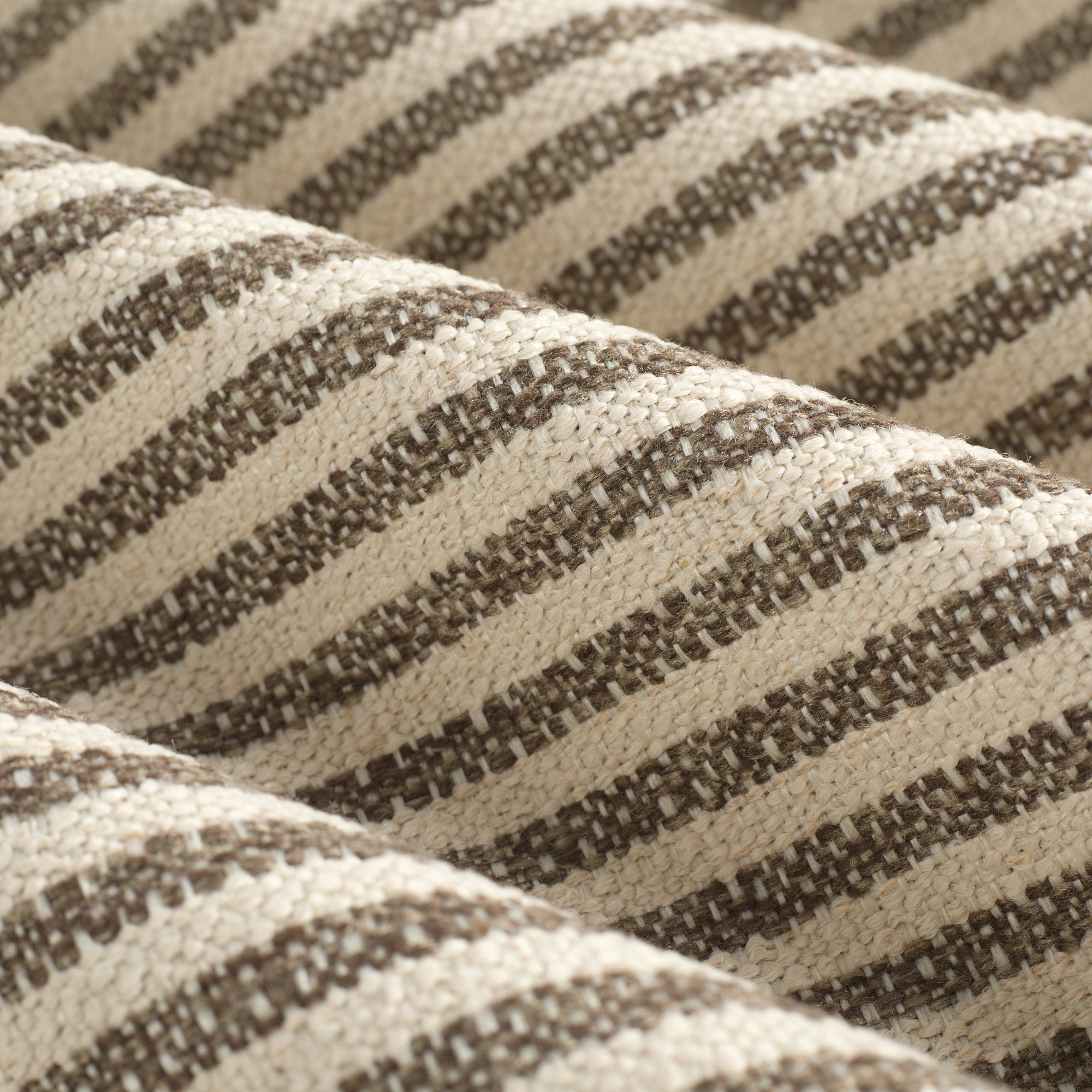 Close up of Tonic Living Crosby Stripe Truffle fabric showing its brown and beige stripes and woven texture.