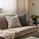 A pair of Tonic Living patterned decorative cushions styled on a velvet sofa.