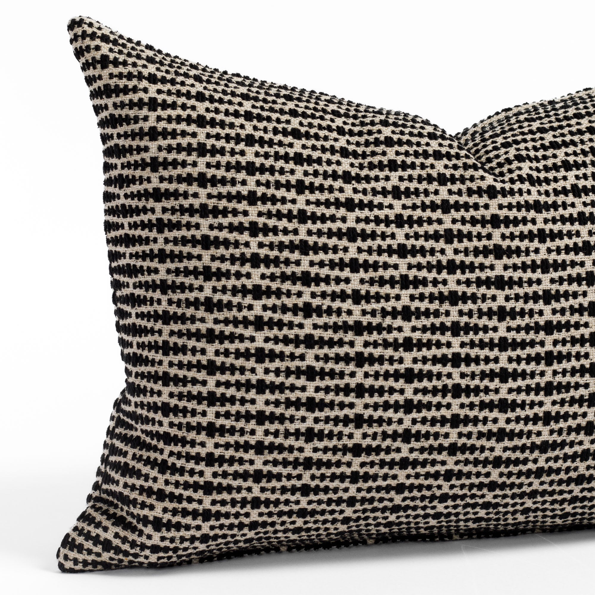 a black and tan geometric patterned lumbar pillow : close up view