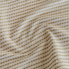 Detail view of Tonic Living Dash Stripe Ochre small-scale striped upholstery fabric.