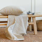 Tonic Living Dash Stripe Ochre neutral stripe upholstery fabric with matching pillow.