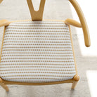 Tonic Living Dash Stripe Ochre striped neutral upholstery fabric on dining chair.