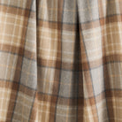 Close up of Tonic Living Duncan Plaid Tweed wool blanket showing its brown, camel, and grey check pattern with subtle herringbone texture.