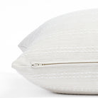a soft white tonal stripe throw pillow: close up zipper view