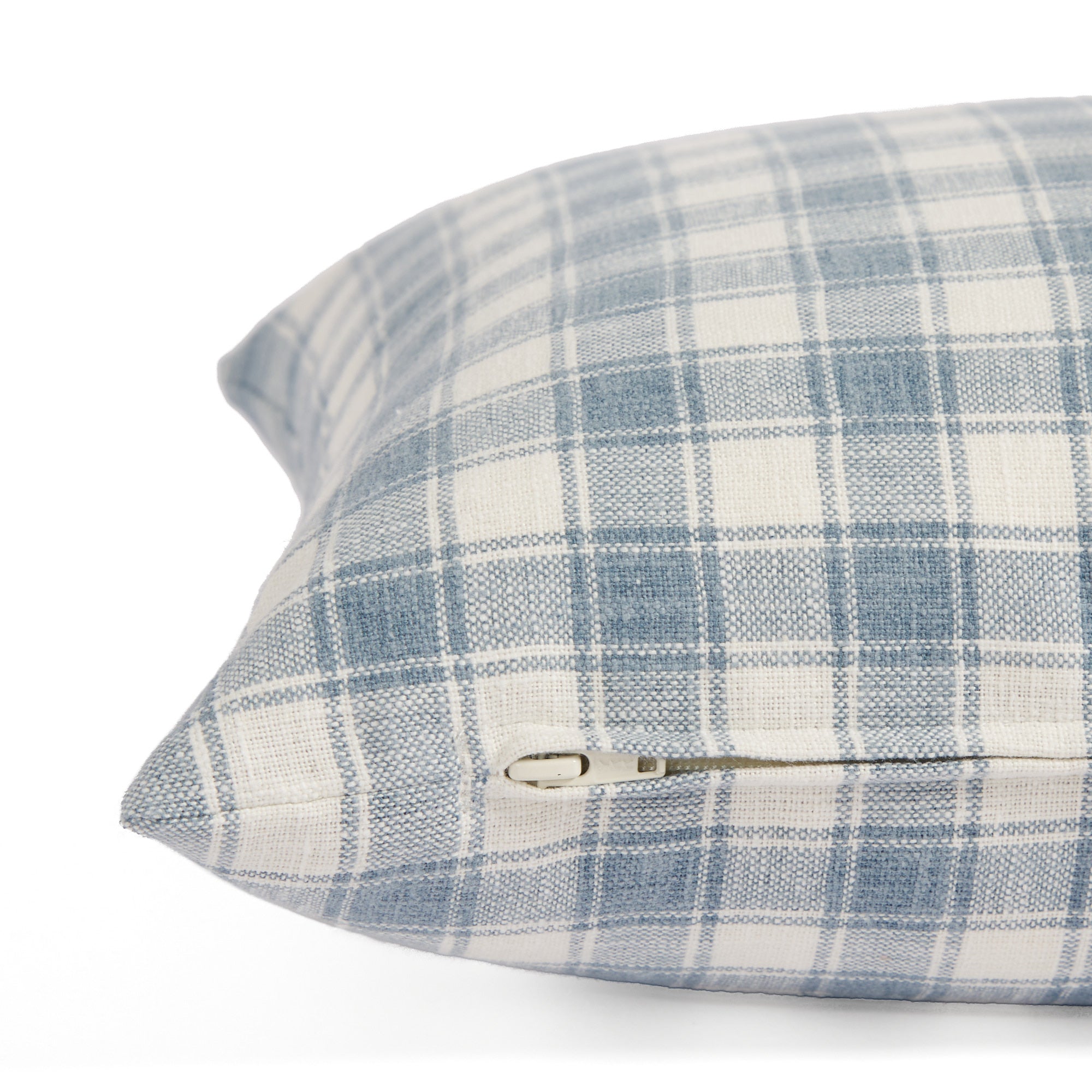 Side zipper detail of Tonic Living Emmett Plaid 14x20 pillow in blue and white plaid.