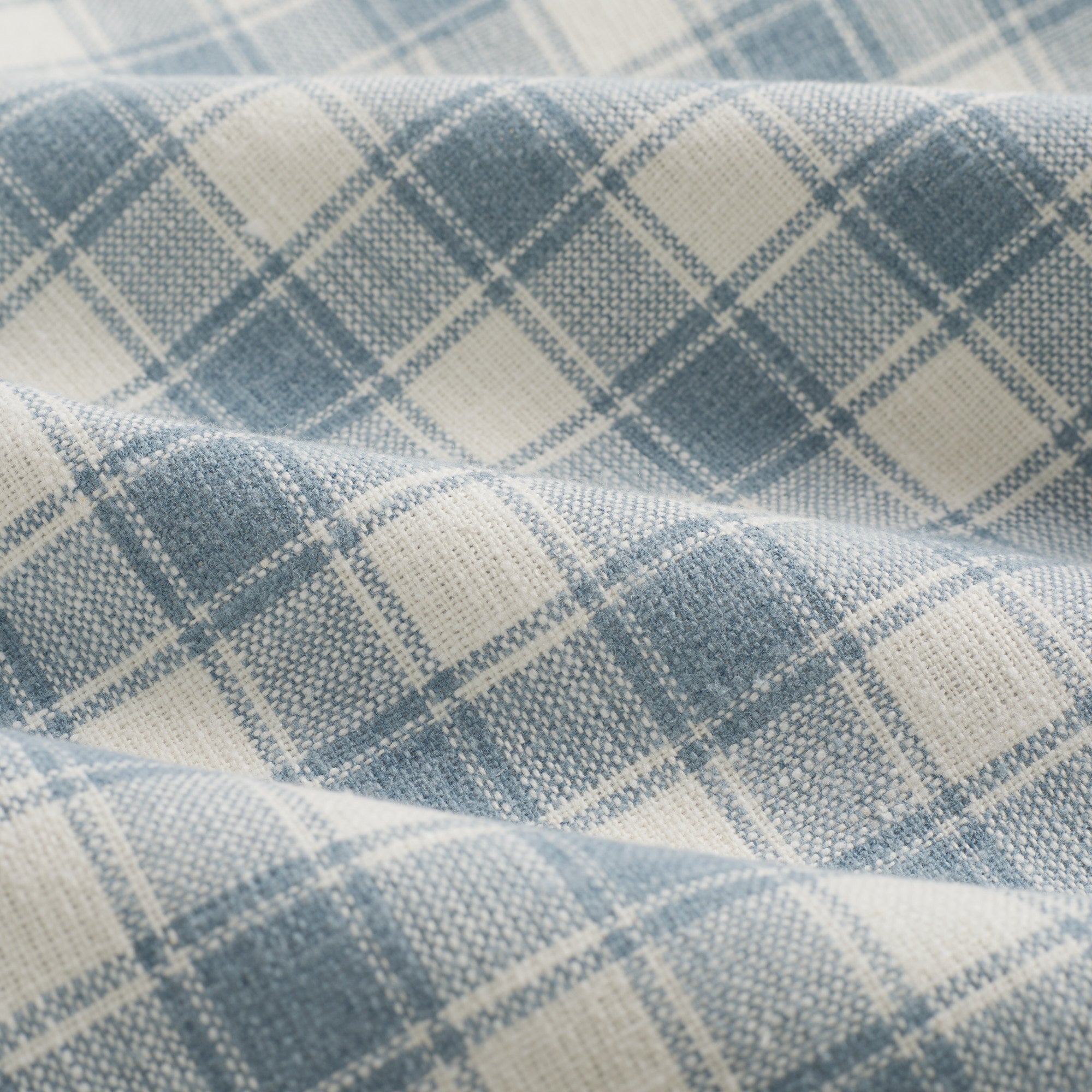 Close up of Tonic Living Emmett Plaid Denim Blue fabric featuring a refined small-scale plaid pattern.