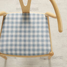 Tonic Living Emmett Plaid Denim Blue upholstery fabric on a dining chair in a classic blue and white plaid.