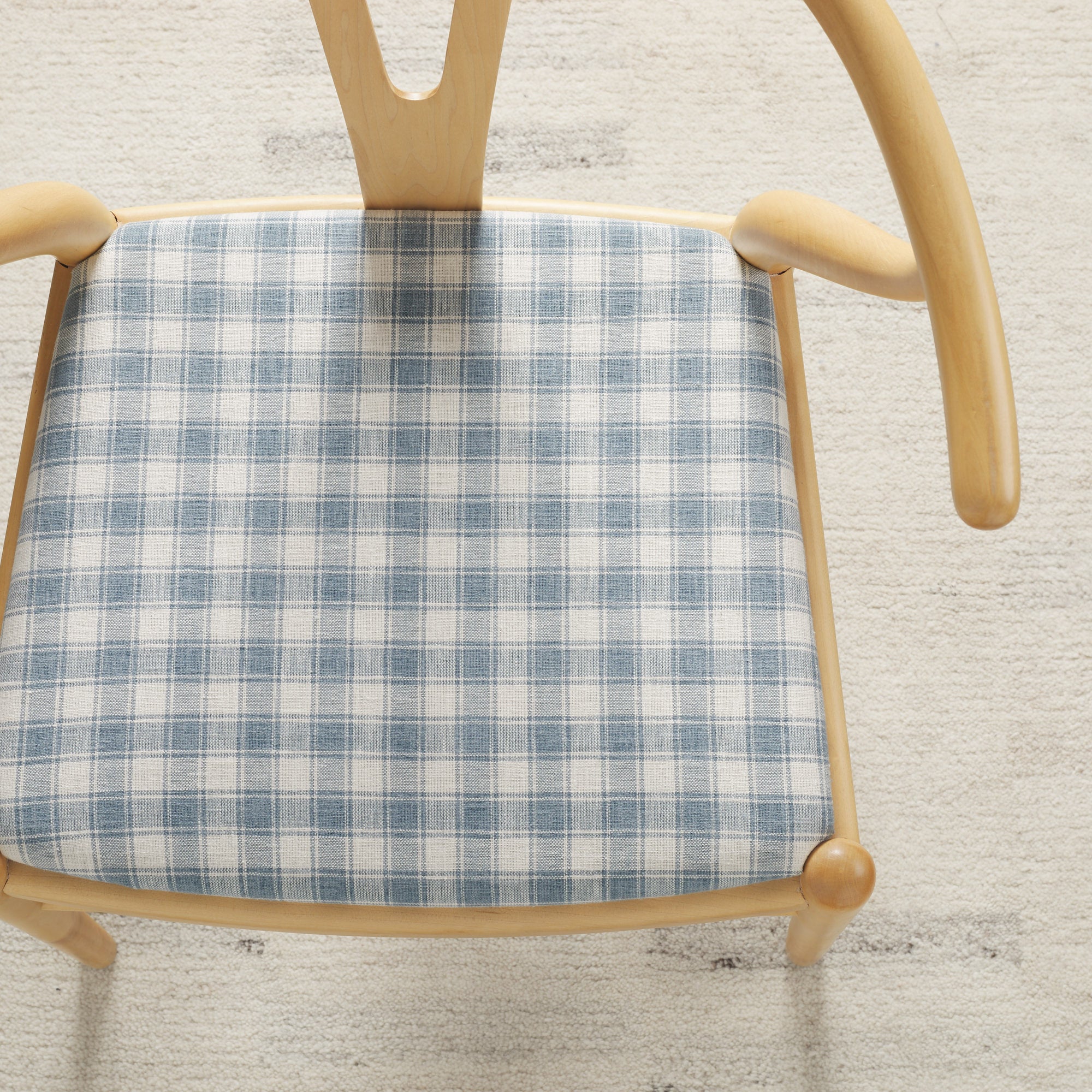 Tonic Living Emmett Plaid Denim Blue upholstery fabric on a dining chair in a classic blue and white plaid.