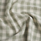 Tonic Living Emmett Plaid Sage upholstery fabric in a versatile light green and white plaid.