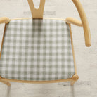 Tonic Living Emmett Plaid Sage upholstery fabric on a dining chair in a classic light green and white plaid.