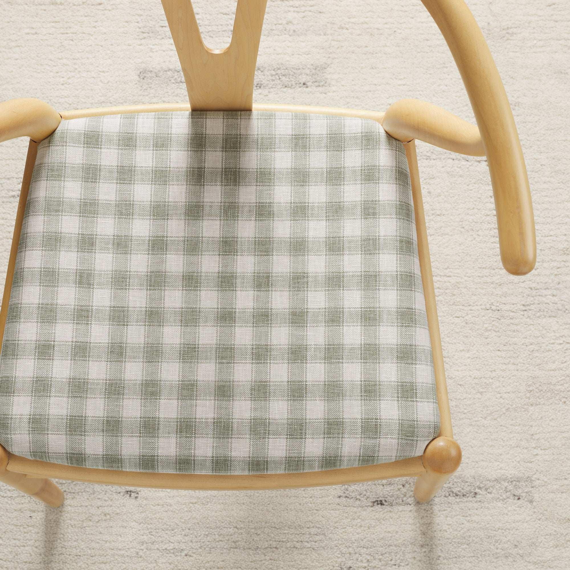 Tonic Living Emmett Plaid Sage upholstery fabric on a dining chair in a classic light green and white plaid.
