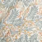 Tonic Living Fable Fabric in Meadow, a soft white botanical drapery fabric with colourful leafy motifs in blue, terracotta, and brown.
