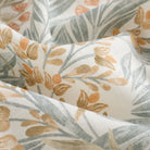 Close up of Tonic Living Fable Meadow curtain fabric showing its floral botanical design in blue, terracotta, light brown, and soft white.