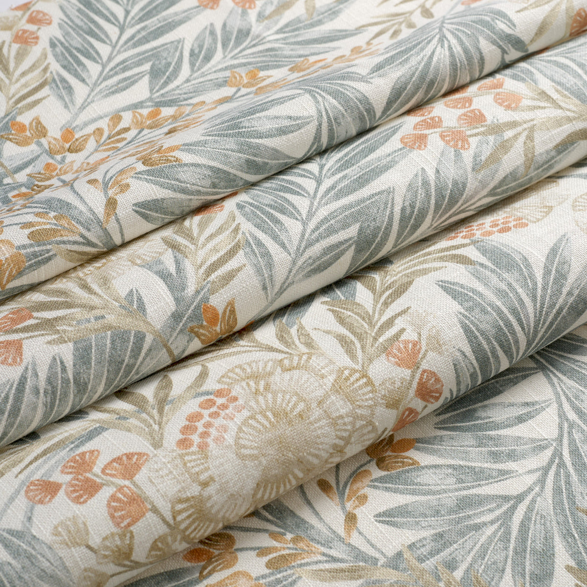 Tonic Living Fable Meadow Fabric shown in soft folds like a Roman shade, featuring a colourful leafy botanical pattern.