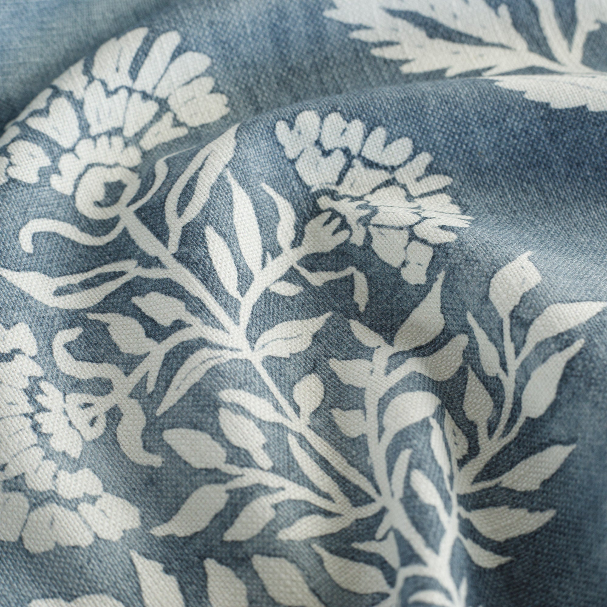 an indigo blue and white floral print fabric : close up view